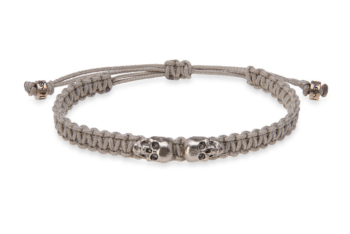 Beige nylon bracelet with bronze skulls