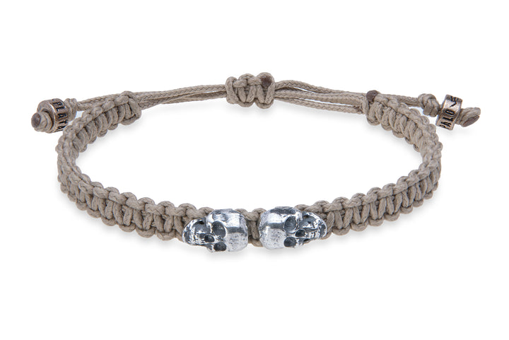 Beige nylon bracelet with silver skulls