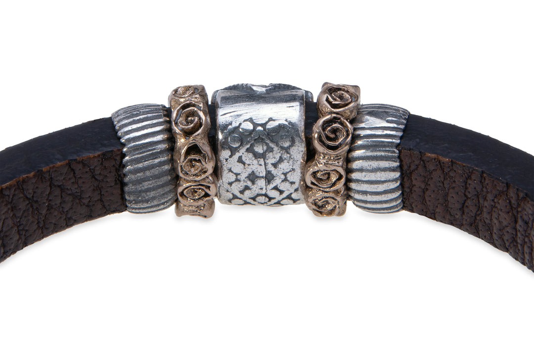 Leather bracelet with silver, bronze and zircon pieces